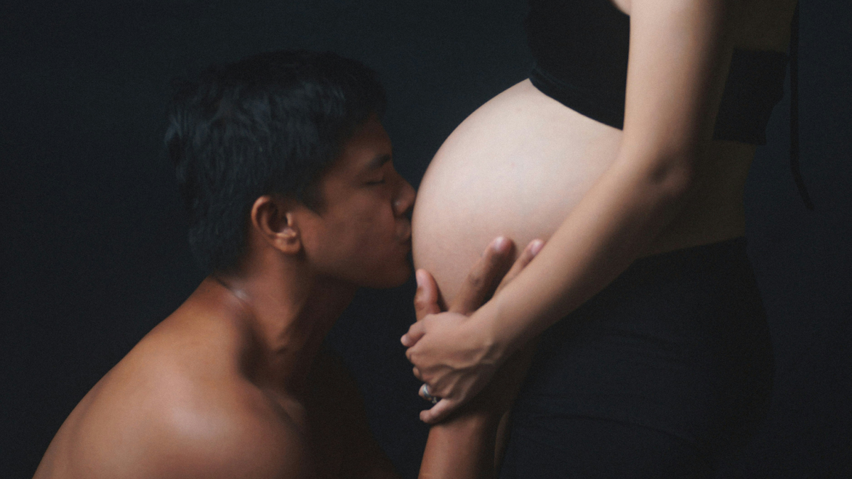 Man Kissing Woman’s Belly