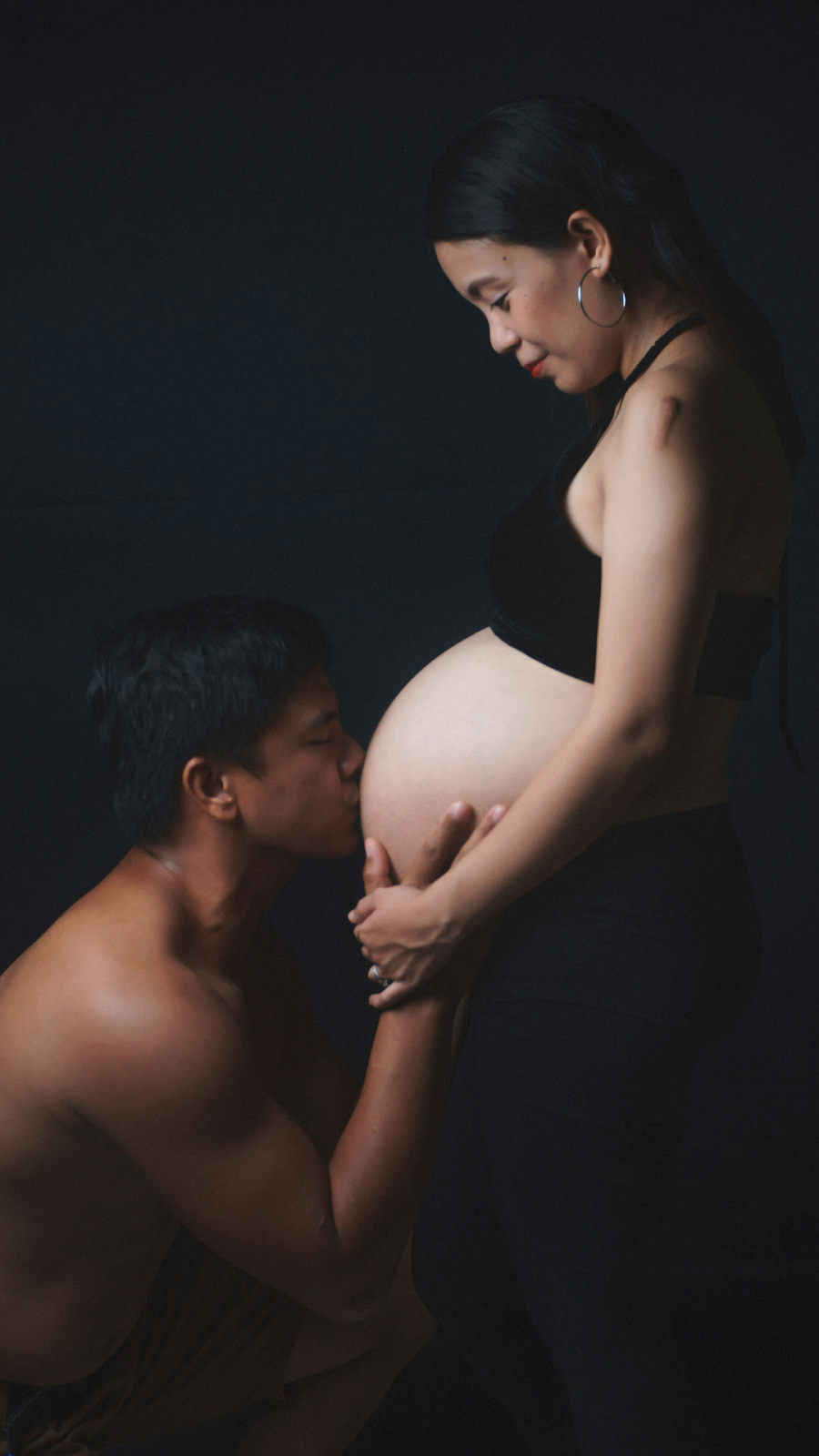 Man Kissing Woman’s Pregnant Belly